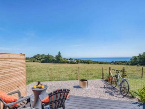 a patio with a bike parked on a wooden deck at Dhunan - Uk7836 in Brodick