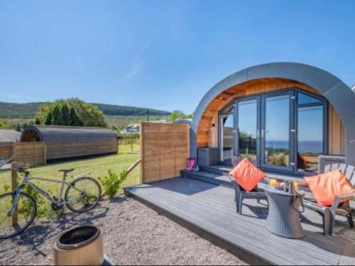 a small dome house with a bike parked on a deck at Dhunan - Uk7836 in Brodick