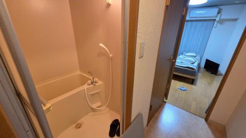 a bathroom with a tub and a toilet and a shower at MORI Apartment Near namba in Osaka
