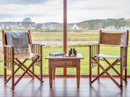two chairs and a table in front of a window at Ford Cottage in Banchory