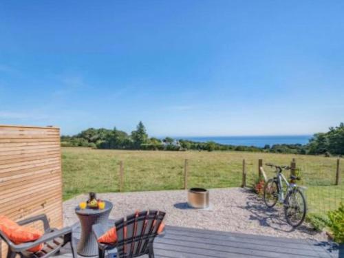 a patio with a bike parked on a wooden deck at Dundhu - Uk7834 in Brodick