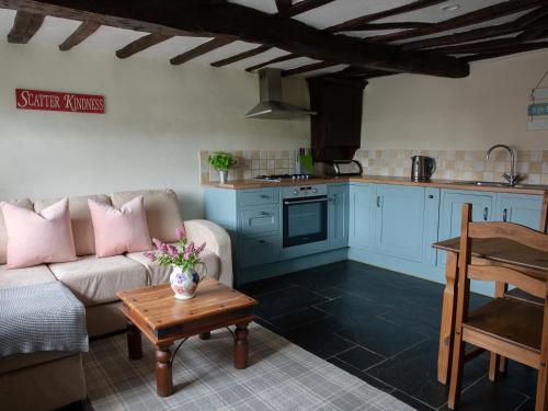 a living room with a couch and a table at The Coach House - Ukc4691 in Kilkhampton