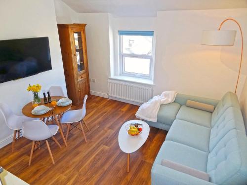 a living room with a couch and a table at Great Orme - Uk2775 in Llandudno