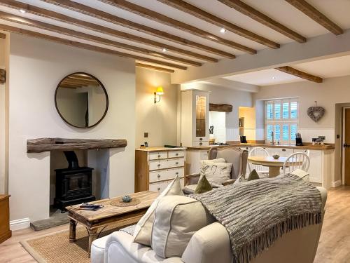 a living room with a couch and a table at Bailey Cottage in Skipton