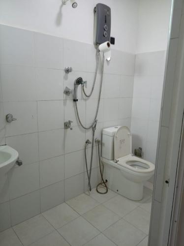 a bathroom with a shower and a toilet in a stall at Bellamoon Resort in Trincomalee