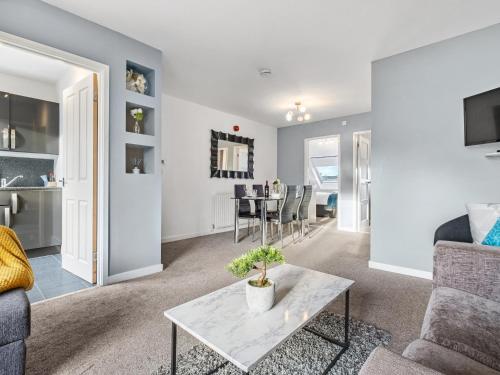 a living room with a couch and a table at Sandyford Apartment in Jesmond