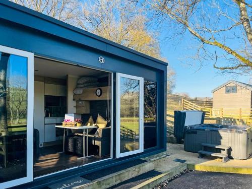 a blue house with a large sliding glass door at The Foxes Den - Ukc8196 in Dolau