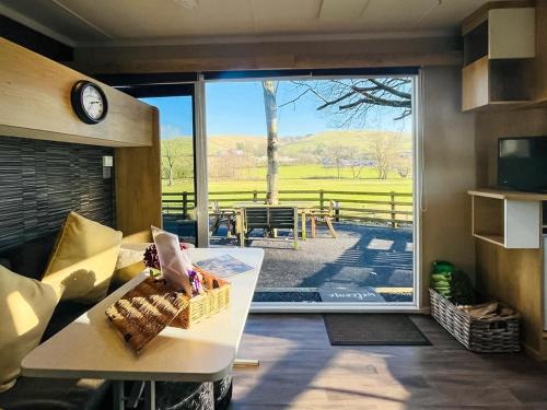 a living room with a large sliding glass door at The Foxes Den - Ukc8196 in Dolau