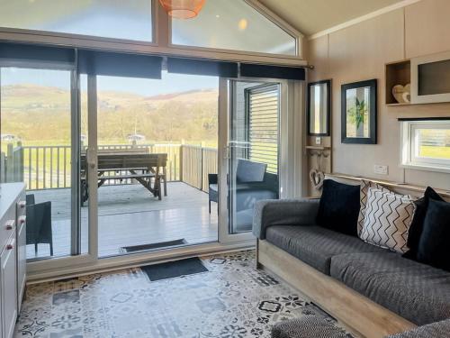 a living room with a couch and a balcony at Oak Tree View - Ukc8193 in Dolau