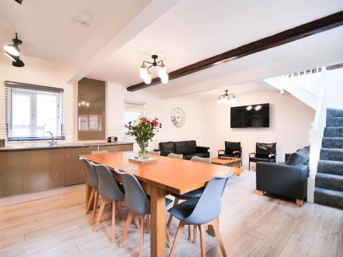 a dining room and living room with a wooden table and chairs at Cottage 2 - Ukc3179 in York