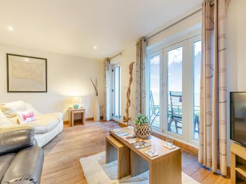 a living room with a couch and a tv at 20 Mount Brioni in Downderry