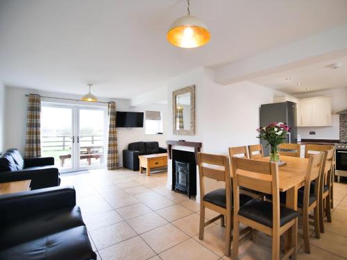 a kitchen and living room with a table and chairs at Cottage 8 - Ukc3185 in York