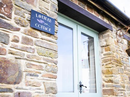 a sign on the side of a brick building at Lavender Cottage - Ukc4695 in Kilkhampton