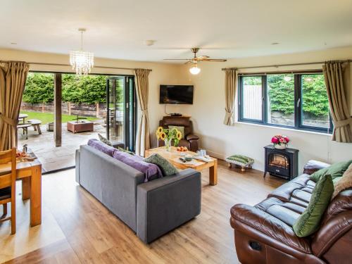 a living room with two couches and a table at Caban Dulas - Ukc8195 in Dolau