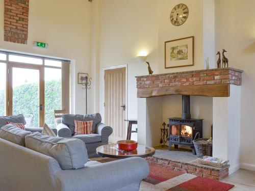 a living room with couches and a fireplace at The Forge-W42942 in Burn