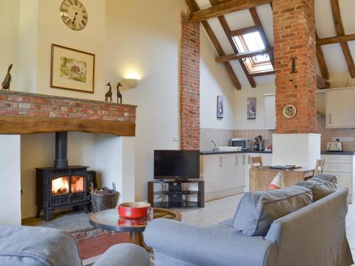 a living room with a couch and a fireplace at The Forge-W42942 in Burn