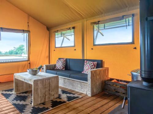 a living room with a couch and a table at Swallow - Safari Tent - Ukc8985 in Romsey