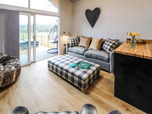 a living room with a couch and a table at Buck Barn - Ukc8185 in Dolau