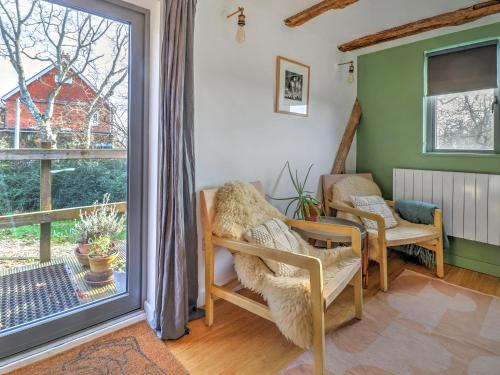 a living room with a sliding glass door to a balcony at Staddlestone Barn - Ukc8984 in Romsey