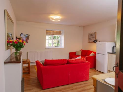 a living room with red furniture and a red couch at Number Five - Ukc4967 in Tawstock