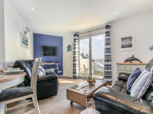 a living room with a couch and a table at 10 Mount Brioni in Downderry