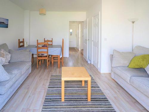 a living room with a couch and a table at Tennyson Cottage in Freshwater