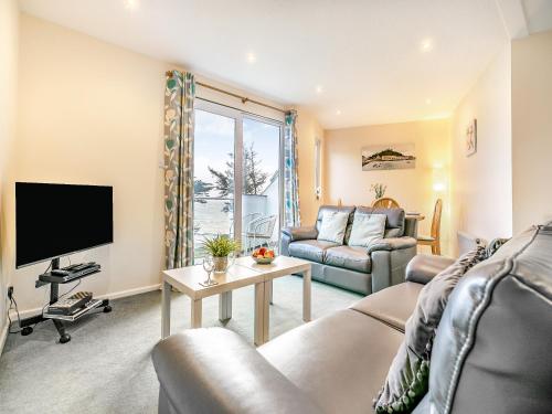 a living room with a couch and a tv at 11 Mount Brioni - Ukc5345 in Torpoint
