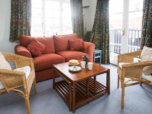 a living room with a couch and a coffee table at 1 Bell Lodge in Thorpeness