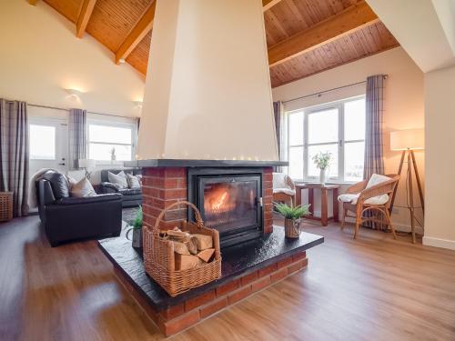 a living room with a brick fireplace in a living room at Eagle 3 Star - Ukc5056 in Aviemore