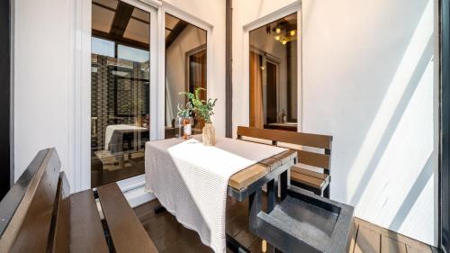 a table on the porch of a house at Buan Cordelia Pool Villa Pension in Buan