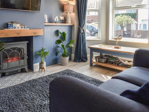 a living room with a couch and a fireplace at Avocet - Ukc5446 in Pakefield