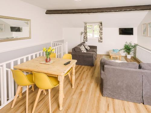 a living room with a wooden table and a couch at Number Two - Ukc4964 in Tawstock