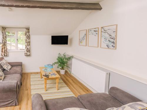 a living room with a couch and a table at Number Two - Ukc4964 in Tawstock