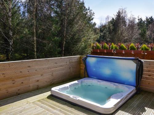 a hot tub sitting on a deck with a fence at Jessie's Corner - Ukc5509 in West Thirston