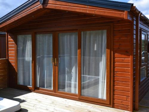 a wooden cabin with large sliding glass doors at Jessie's Corner - Ukc5509 in West Thirston