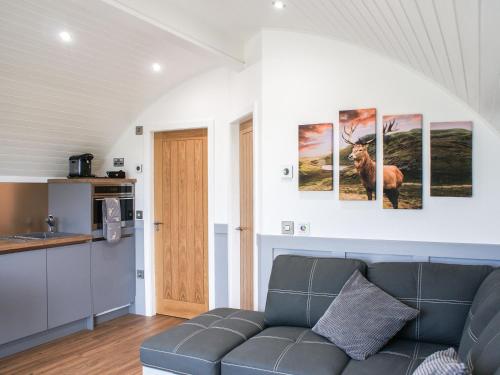 a living room with a couch and some pictures on the wall at Knockan - Ukc6026 in Newmill