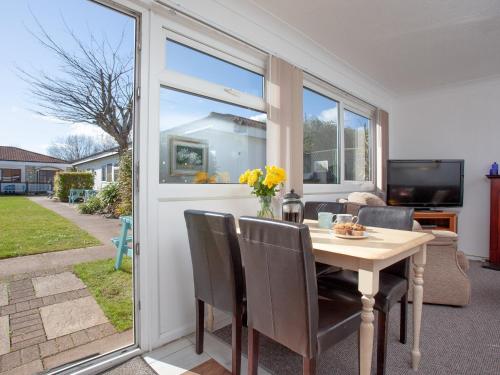 a dining room with a table and a window at 310 The Cove - Ukc5025 in Dawlish