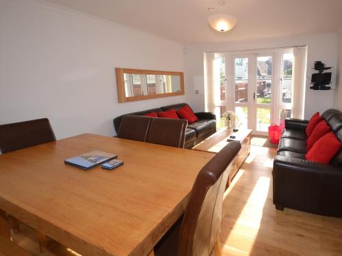 a living room with a wooden table and a couch at The Sanctuary in Sandown