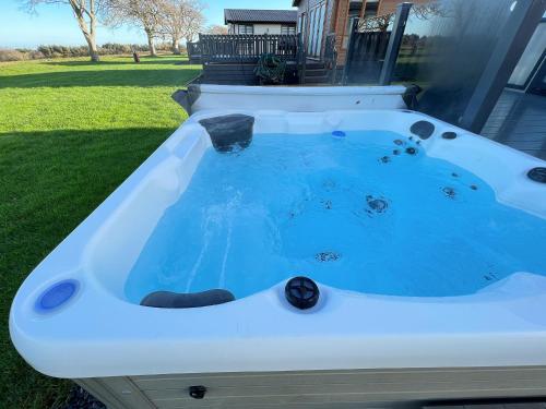 a hot tub in the backyard of a house at Knightsbridge 30 in Cameron