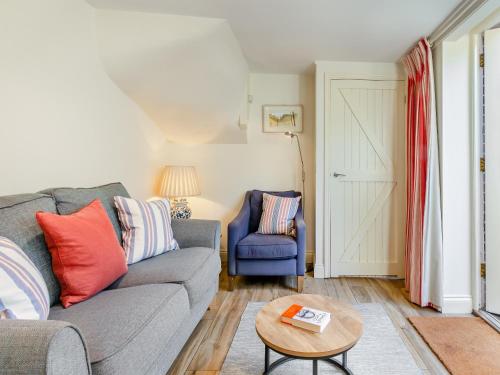 a living room with a couch and a table at White Cottage - Ukc6133 in Eastdean