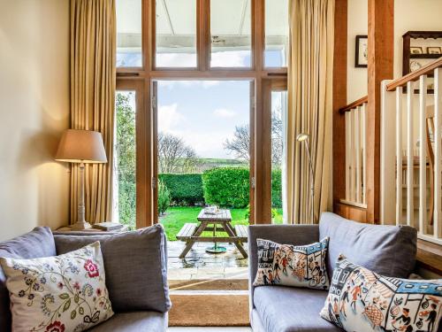 a living room with a couch and a large glass door at Beachy Barn - Ukc6126 in Eastdean