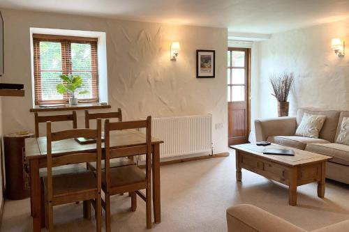 a living room with a couch and a table at Towan Cottage - Cwc79064 in Perranporth