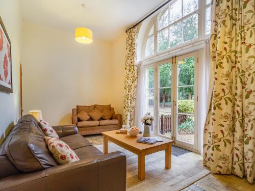 a living room with a couch and a table at The Amherst House in Bury Saint Edmunds