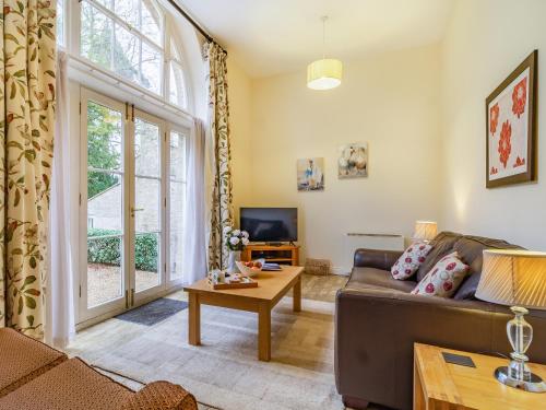 a living room with a couch and a table at The Amherst House in Bury Saint Edmunds