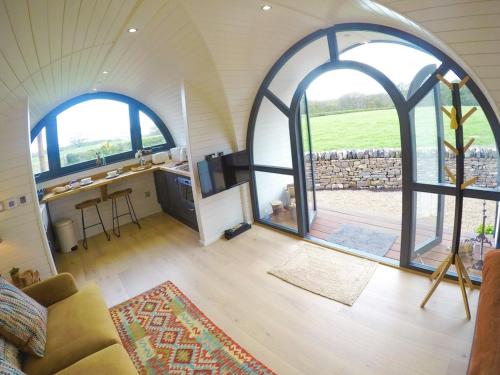 a room with two large arched windows in a house at Oak Tree Retreat in Dronfield