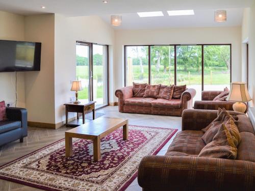 a living room with two couches and a tv at The Farmhouse - Ukc6250 in Linlithgow