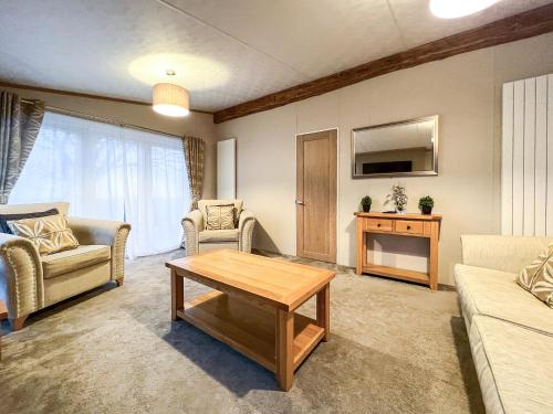 a living room with a couch and a coffee table at Saltire 26 in St. Andrews