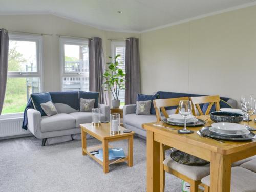 a living room with a couch and a table at Unwind 37 - Uk43980 in West Thirston