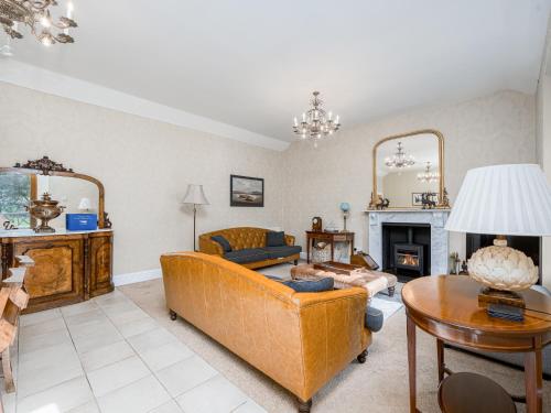 a living room with a couch and a fireplace at The Servant's Hall - Ukc6964 in Carnoustie