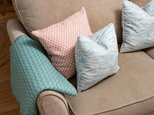 four pillows are sitting on a couch at Fishermans's Rest in Lossiemouth